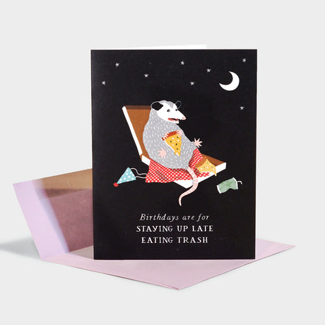 Birthday card with illustration of a possum eating pizza out of a pizza box.
