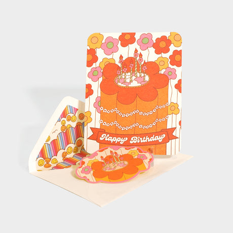 Greeting card with die-cut sealing sticker. Features a birthday cake with retro style floral motifs.