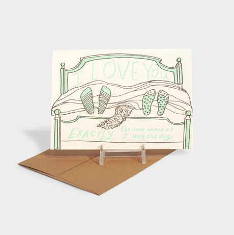 Letterpress greeting card featuring two pairs of feet and a dog's tail peeking out of  bed.