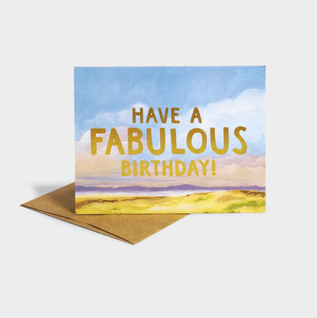 Greeting card with an illustration of a mountainous view. Features gold foil-stamped typography.