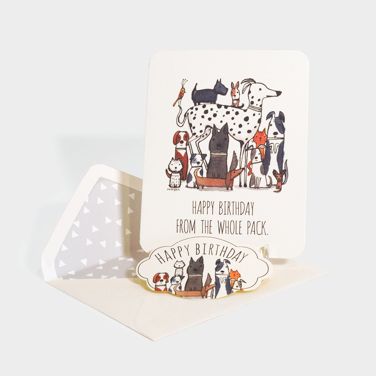 Greeting card with envelope and die-cut sealing sticker. Features an illustration of a pack of various breeds of dogs.