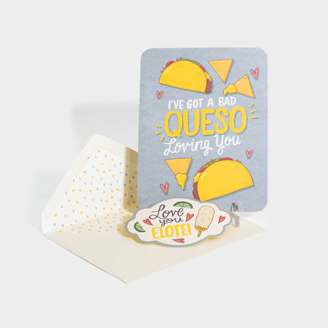 Greeting card with die-cut sealing sticker. Card features cheesy taco and corn chip illustrations with hearts. Die-cut sticker features lime, hearts, and an elote illustration.