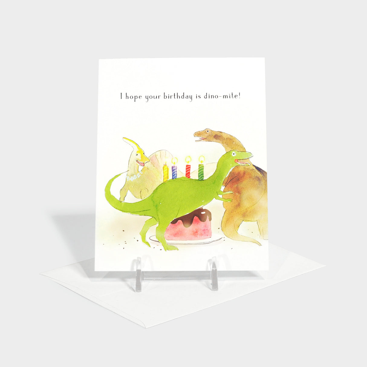 Greeting card with illustration of dinosaurs around a birthday cake.