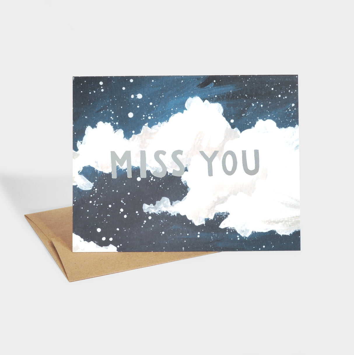 Greeting card with illustration of a cloudy night sky and silver foil-stamped typography.