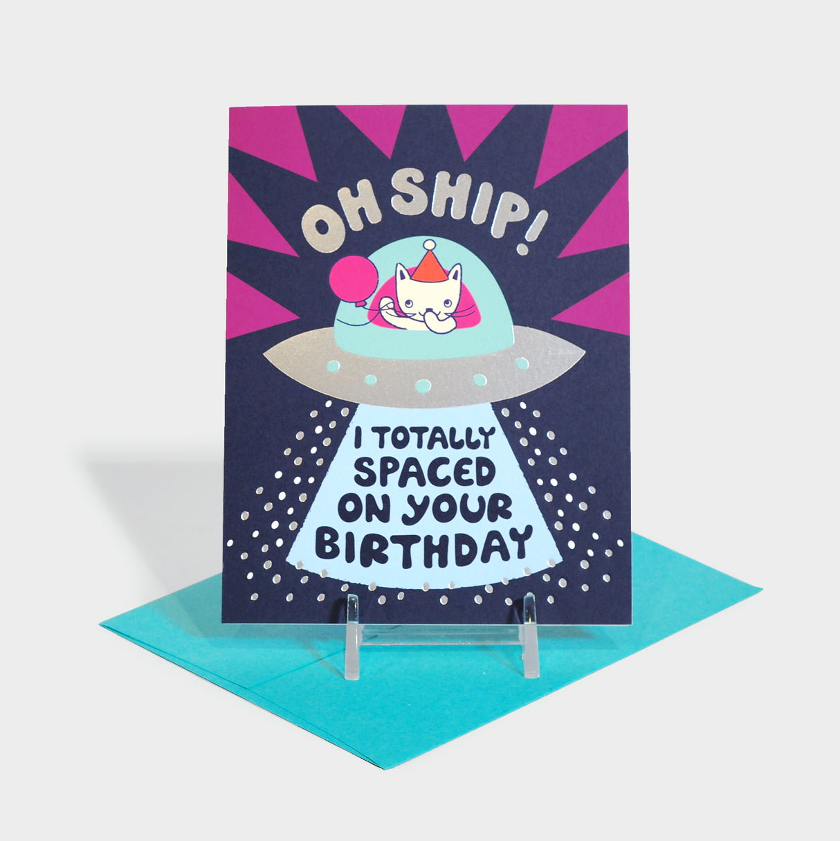 Greeting card with a cat in a balloon and party hat sitting in a space ship.