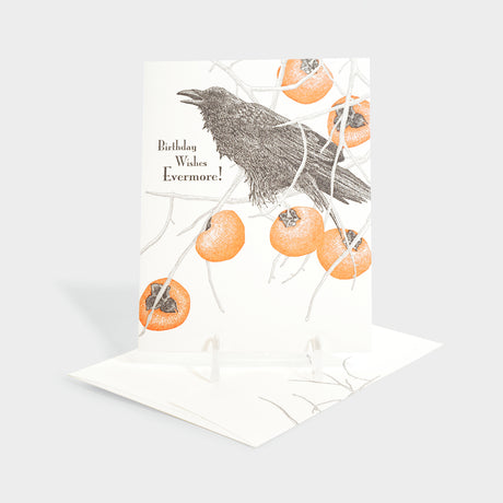 Greeting card with raven and persimmon motifs.