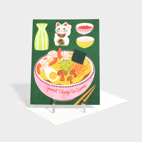 Greeting card with lucky cat and ramen bowl illustrations.