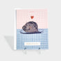 Greeting card with an illustration of a seal with a heart floating above its head.