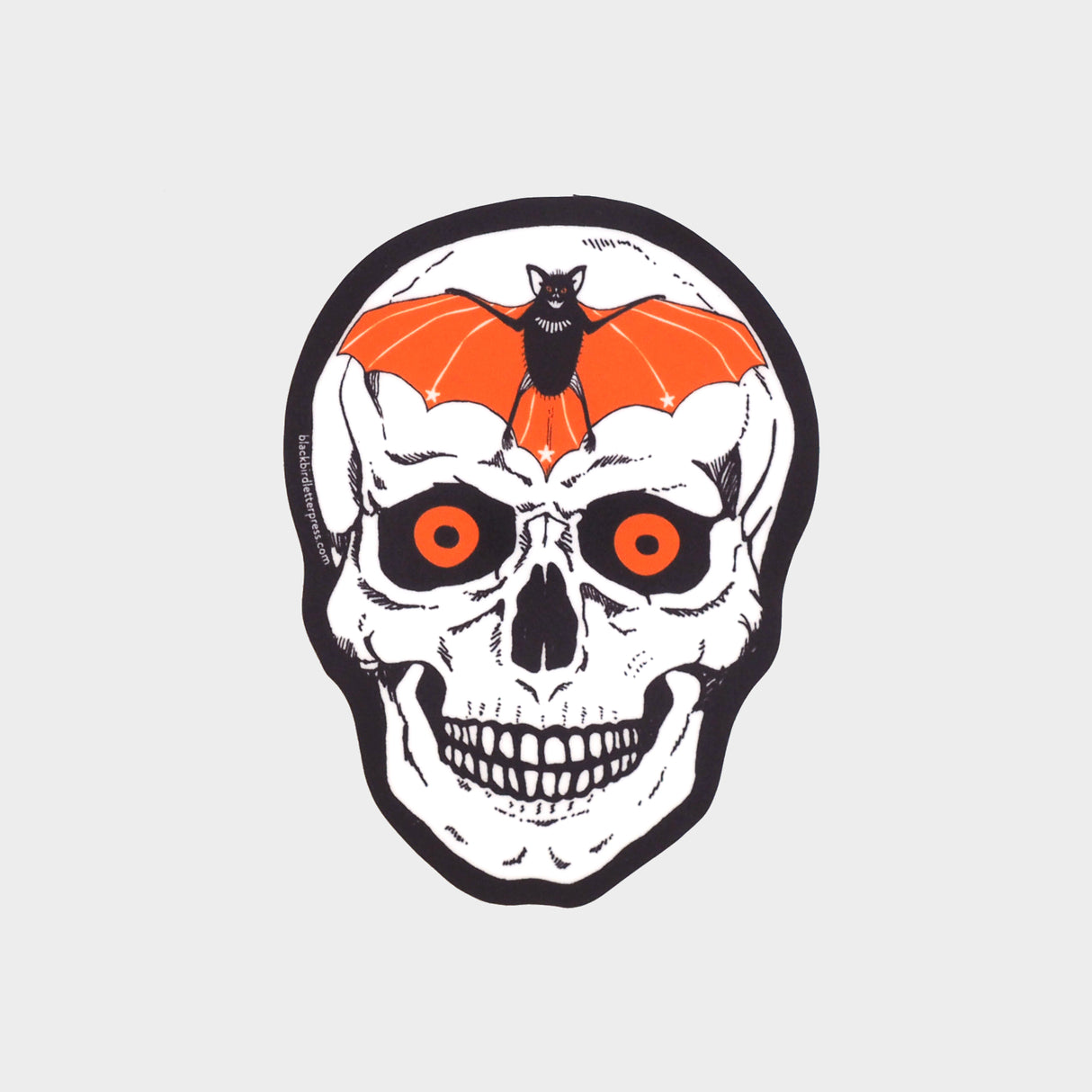 Die-cut, vinyl sticker featuring a skull with glowing orange eyes and a bat over the forehead.