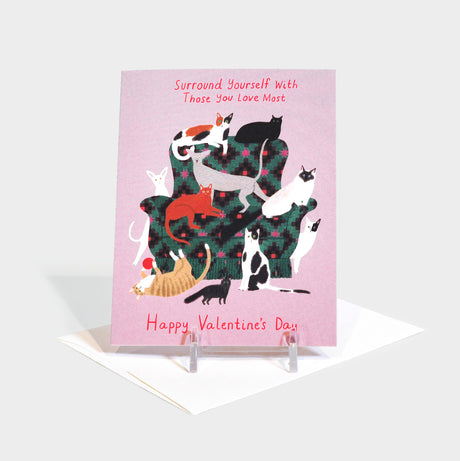 Greeting card with illustration of cats sitting on and around an armchair.